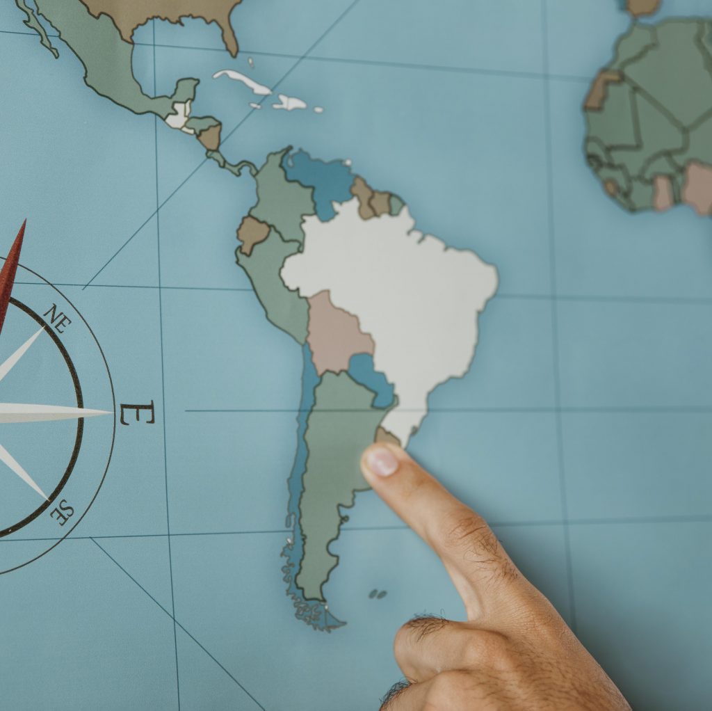Person Pointing To South America On The Map 1024x1022 